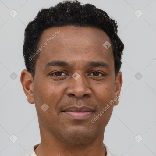Joyful black young-adult male with short  brown hair and brown eyes