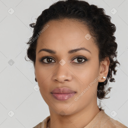 Joyful black young-adult female with long  brown hair and brown eyes