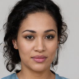 Joyful latino young-adult female with medium  brown hair and brown eyes