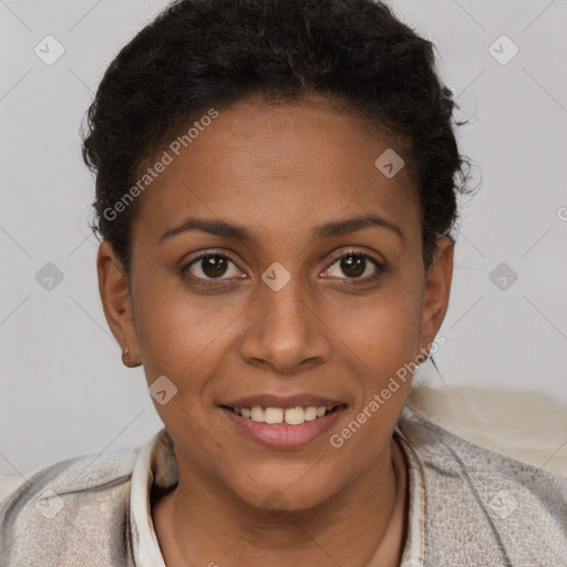 Joyful black young-adult female with short  brown hair and brown eyes