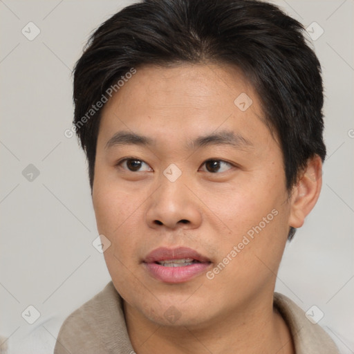 Joyful asian young-adult male with short  brown hair and brown eyes