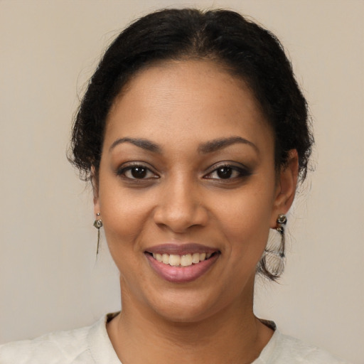 Joyful latino young-adult female with short  brown hair and brown eyes