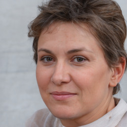 Joyful white adult female with short  brown hair and brown eyes