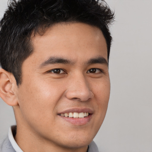 Joyful asian young-adult male with short  brown hair and brown eyes
