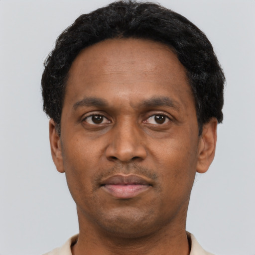 Neutral latino adult male with short  black hair and brown eyes