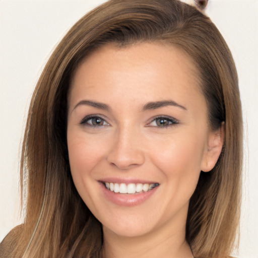 Joyful white young-adult female with long  brown hair and brown eyes