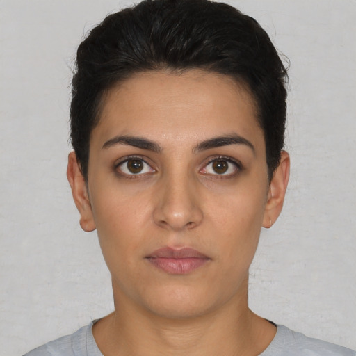 Neutral white young-adult female with short  black hair and brown eyes