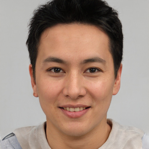 Joyful asian young-adult male with short  brown hair and brown eyes