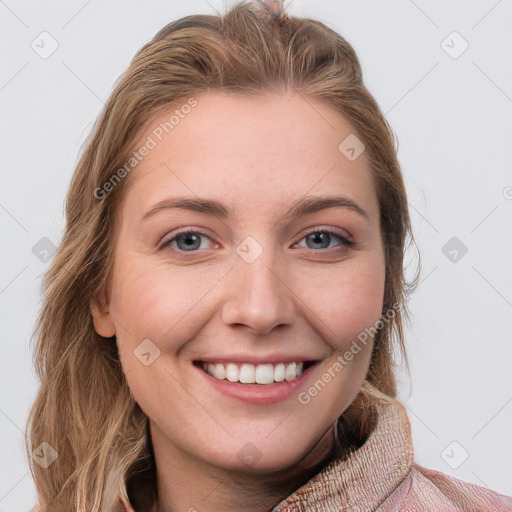 Joyful white young-adult female with long  brown hair and blue eyes