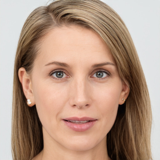 Joyful white young-adult female with long  brown hair and blue eyes