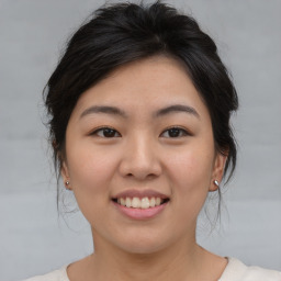 Joyful asian young-adult female with medium  brown hair and brown eyes