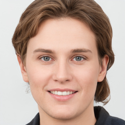 Joyful white young-adult female with medium  brown hair and grey eyes