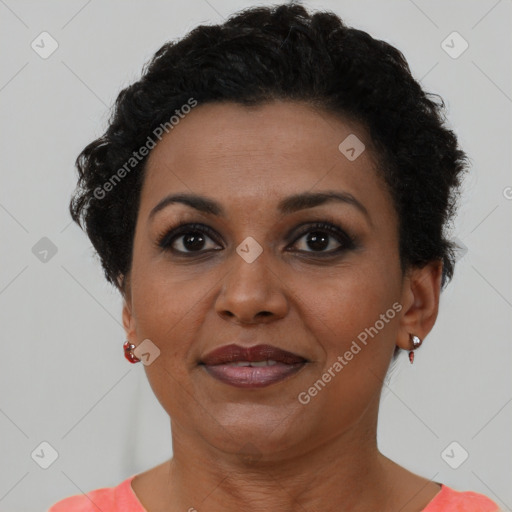Joyful black adult female with short  brown hair and brown eyes