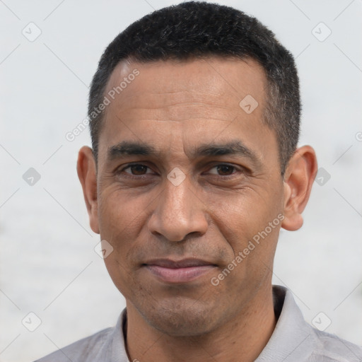 Joyful white adult male with short  black hair and brown eyes