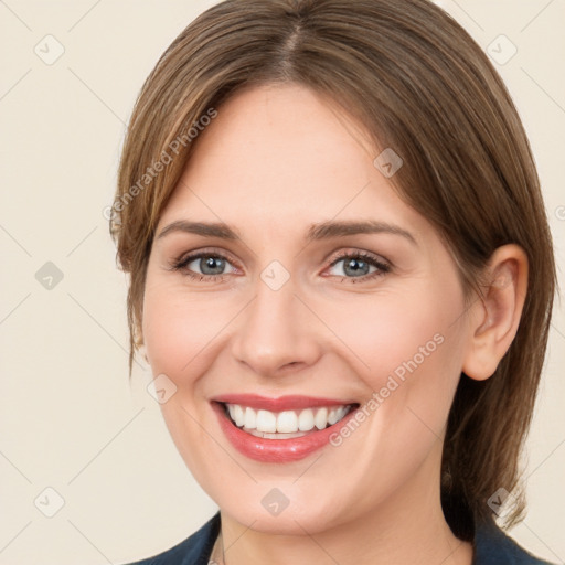 Joyful white young-adult female with medium  brown hair and grey eyes