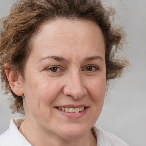 Joyful white adult female with medium  brown hair and brown eyes