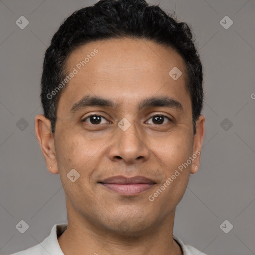 Joyful latino young-adult male with short  black hair and brown eyes