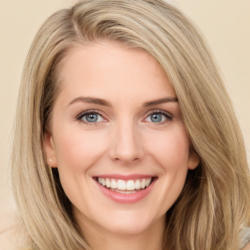 Joyful white young-adult female with long  brown hair and green eyes