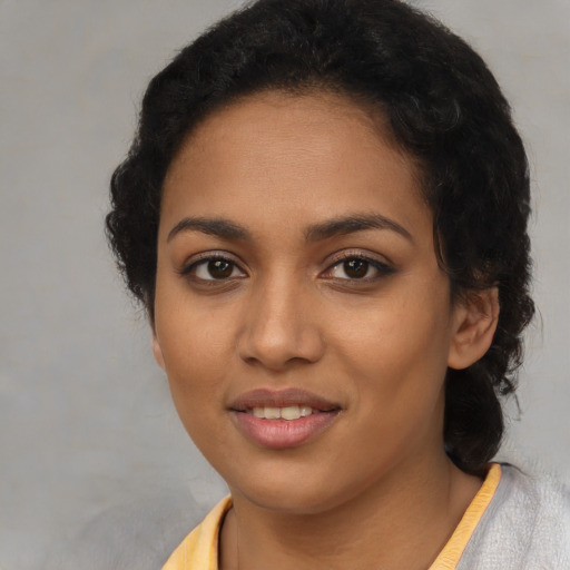 Joyful latino young-adult female with short  black hair and brown eyes