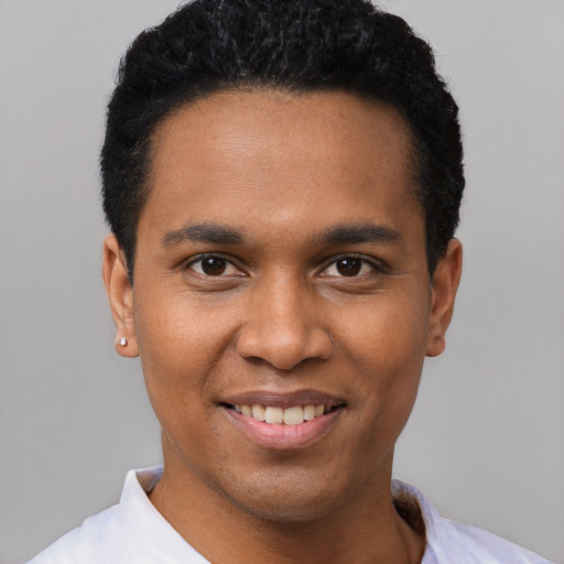 Joyful black young-adult male with short  black hair and brown eyes