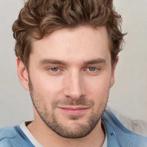 Joyful white young-adult male with short  brown hair and blue eyes