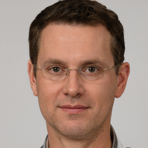 Joyful white adult male with short  brown hair and grey eyes