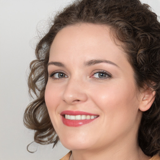 Joyful white young-adult female with medium  brown hair and green eyes