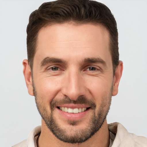 Joyful white young-adult male with short  brown hair and brown eyes