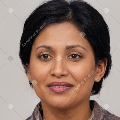 Joyful latino adult female with medium  brown hair and brown eyes