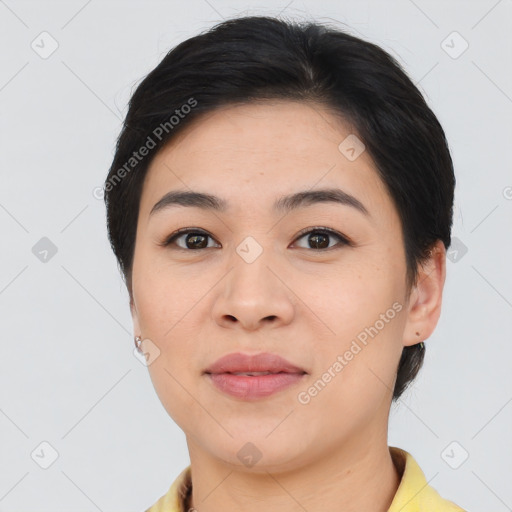 Joyful asian young-adult female with short  black hair and brown eyes