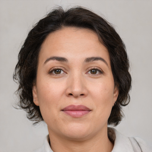 Joyful white adult female with medium  brown hair and brown eyes