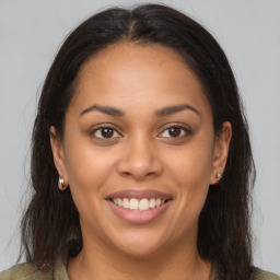 Joyful latino young-adult female with medium  brown hair and brown eyes