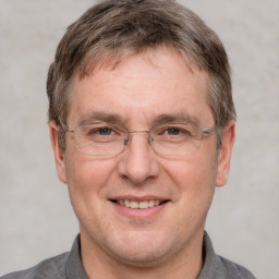 Joyful white adult male with short  brown hair and grey eyes