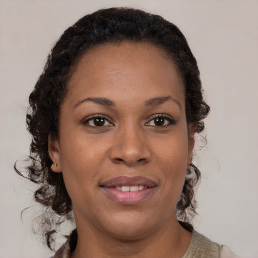 Joyful black young-adult female with medium  brown hair and brown eyes