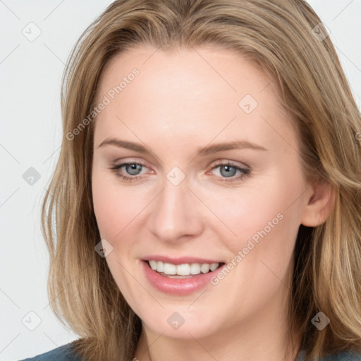 Joyful white young-adult female with long  brown hair and blue eyes