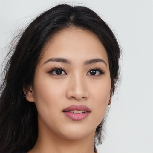 Joyful asian young-adult female with long  black hair and brown eyes