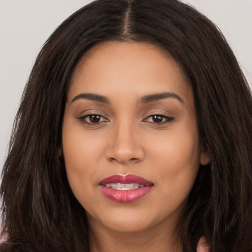 Joyful white young-adult female with long  brown hair and brown eyes