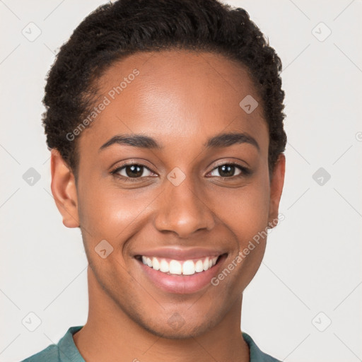 Joyful black young-adult female with short  brown hair and brown eyes