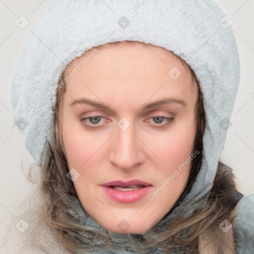 Joyful white young-adult female with long  brown hair and blue eyes