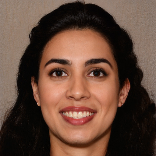 Joyful white young-adult female with long  black hair and brown eyes