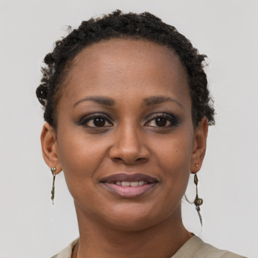 Joyful black young-adult female with short  brown hair and brown eyes