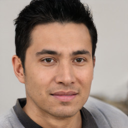 Joyful asian young-adult male with short  brown hair and brown eyes