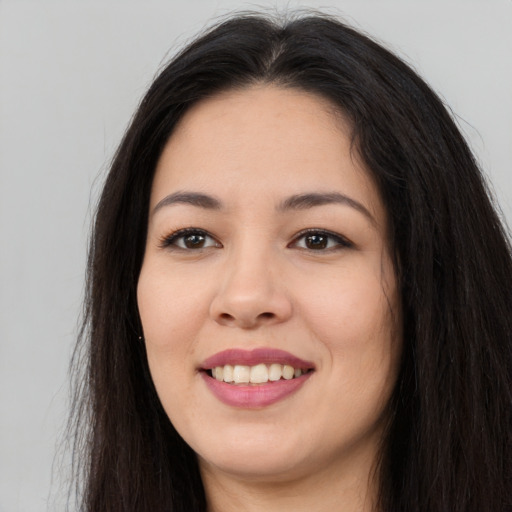 Joyful asian young-adult female with long  brown hair and brown eyes
