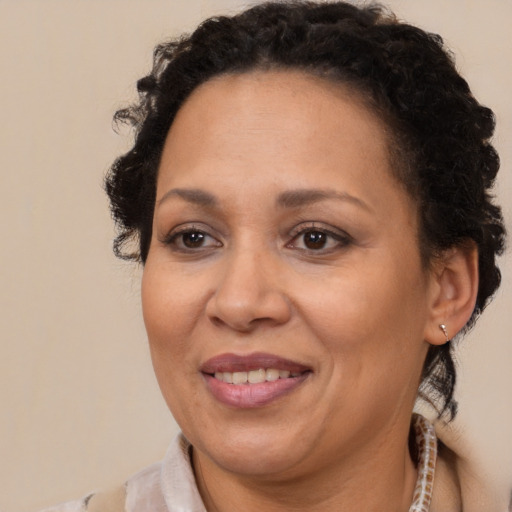 Joyful latino adult female with short  brown hair and brown eyes