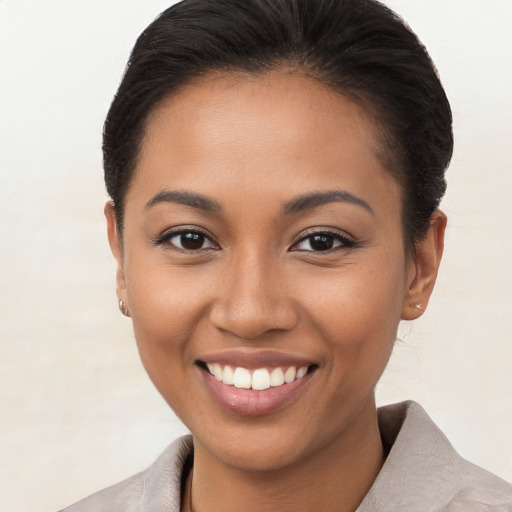 Joyful latino young-adult female with short  brown hair and brown eyes