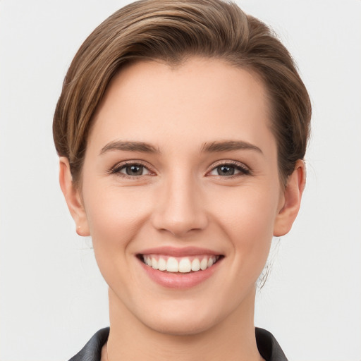 Joyful white young-adult female with short  brown hair and grey eyes