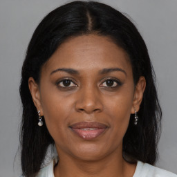 Joyful black young-adult female with medium  brown hair and brown eyes