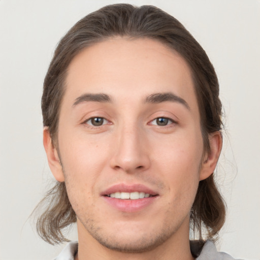 Joyful white young-adult male with medium  brown hair and brown eyes