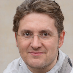 Joyful white adult male with short  brown hair and grey eyes