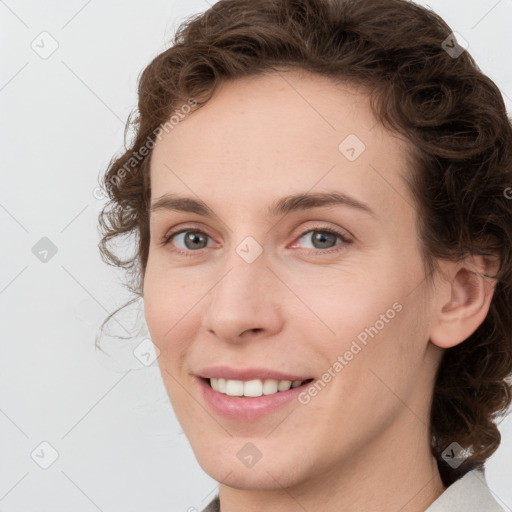 Joyful white young-adult female with medium  brown hair and green eyes